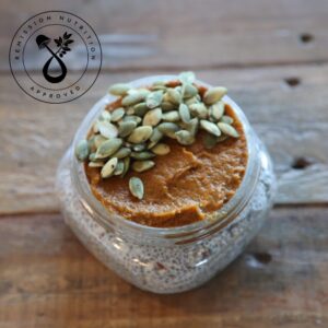 Chia Flax Pumpkin Pudding topped with pumpkin seeds, rich in protein and healthy fats, served in a jar.